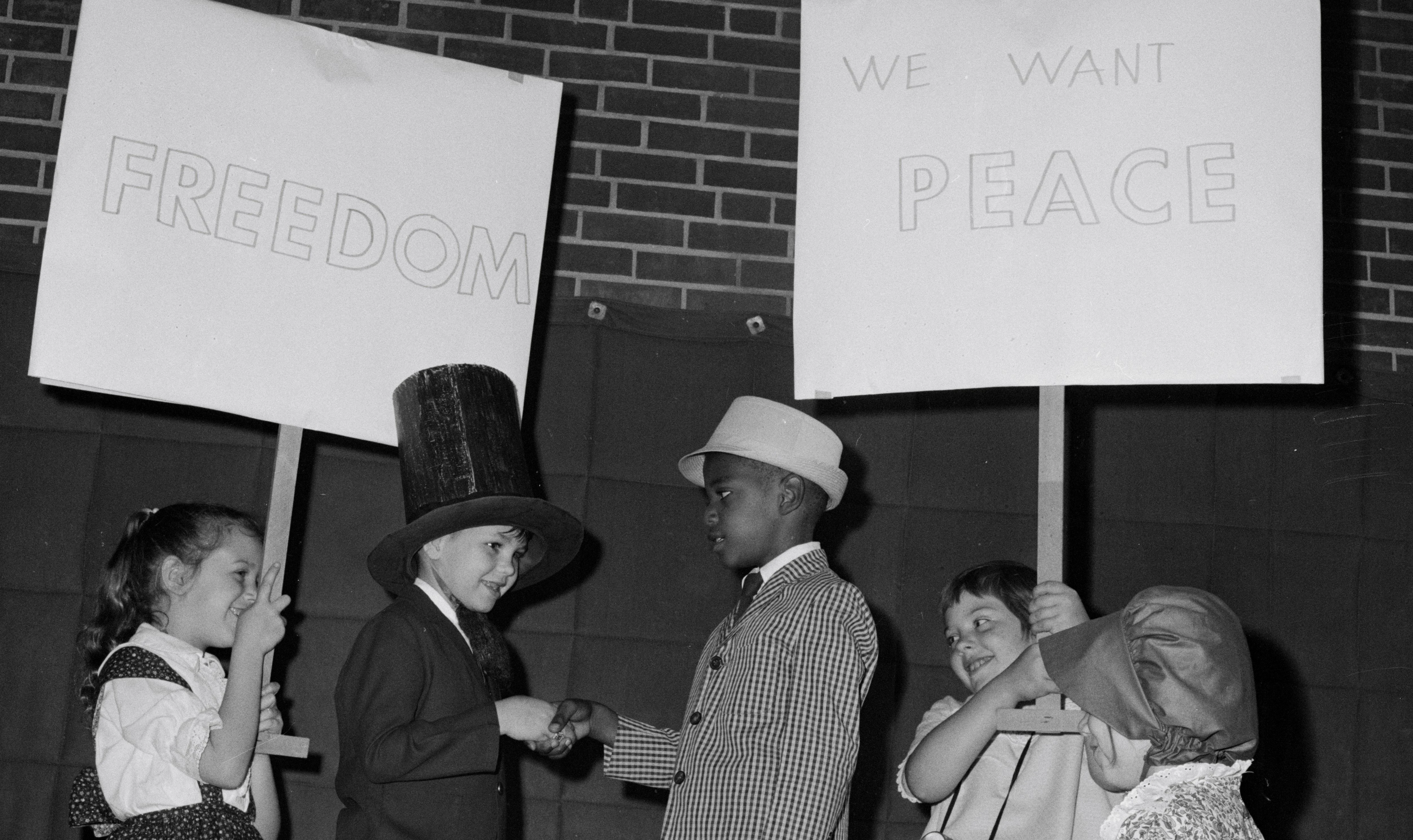 A child holds a sign that says