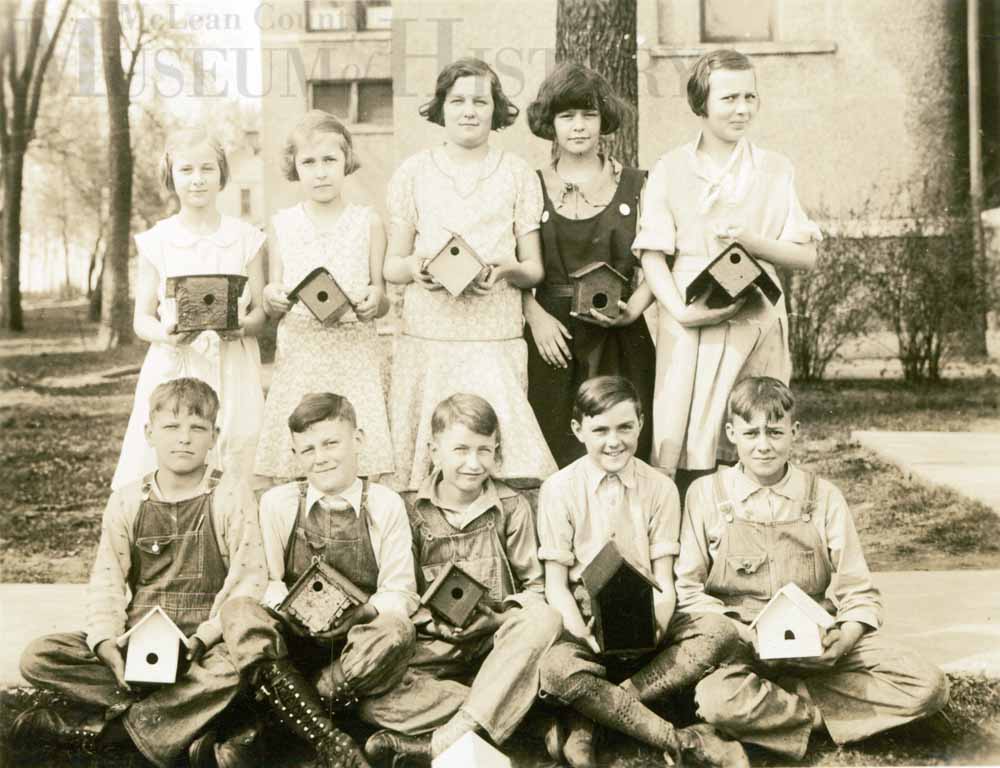 Elementary school children with homemade birdfeeders, 1930s.