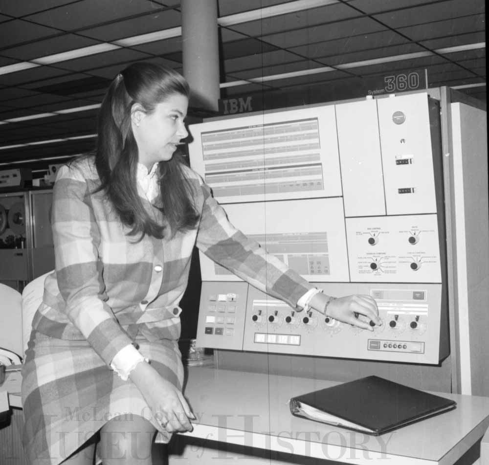 Susan Emrath sitting in front of an old computer, 1968.