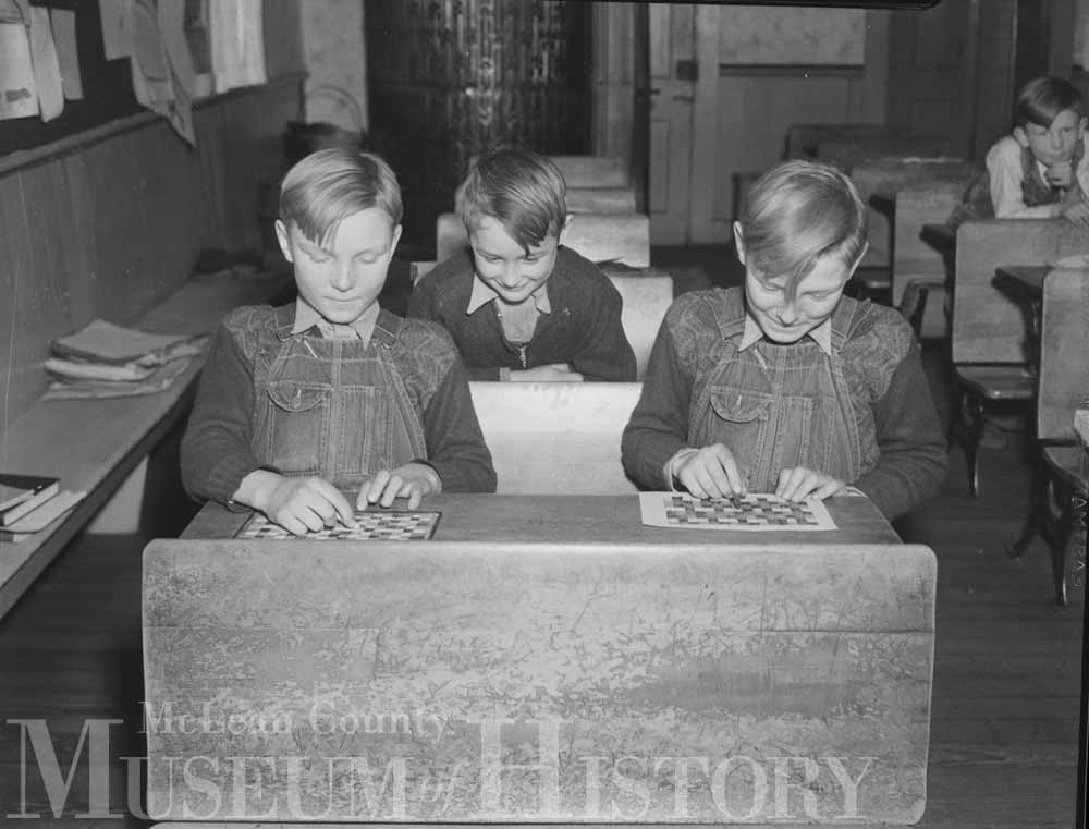 Three boys in school constructing a model home, 1938