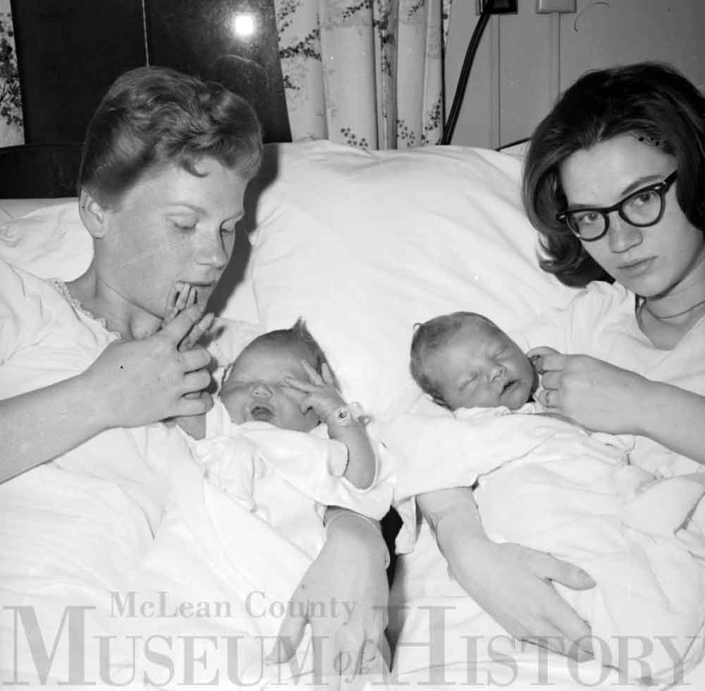 Two women holding their newborn babies, 1965.