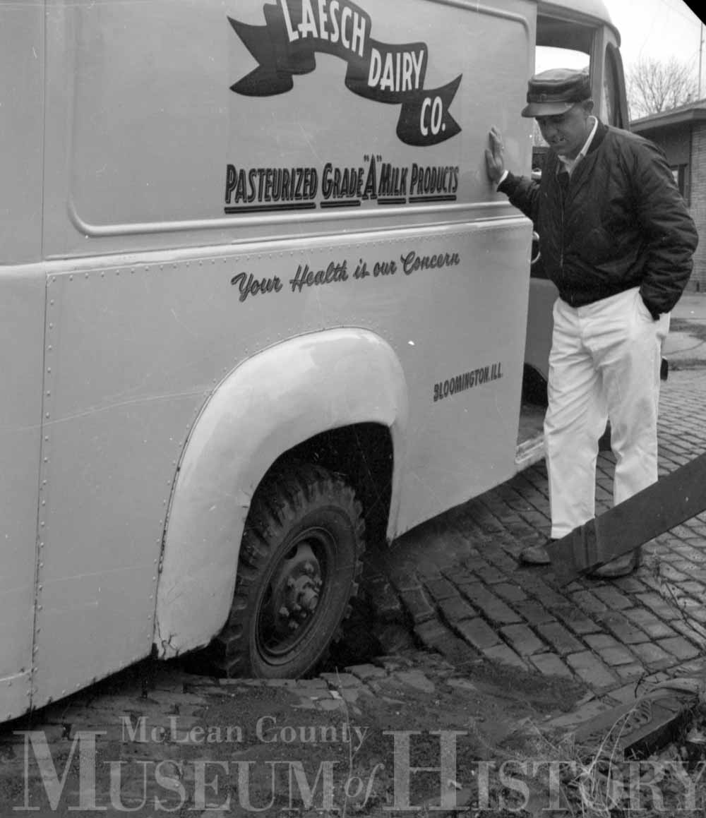 Man in front of a dairy truck, 1965.