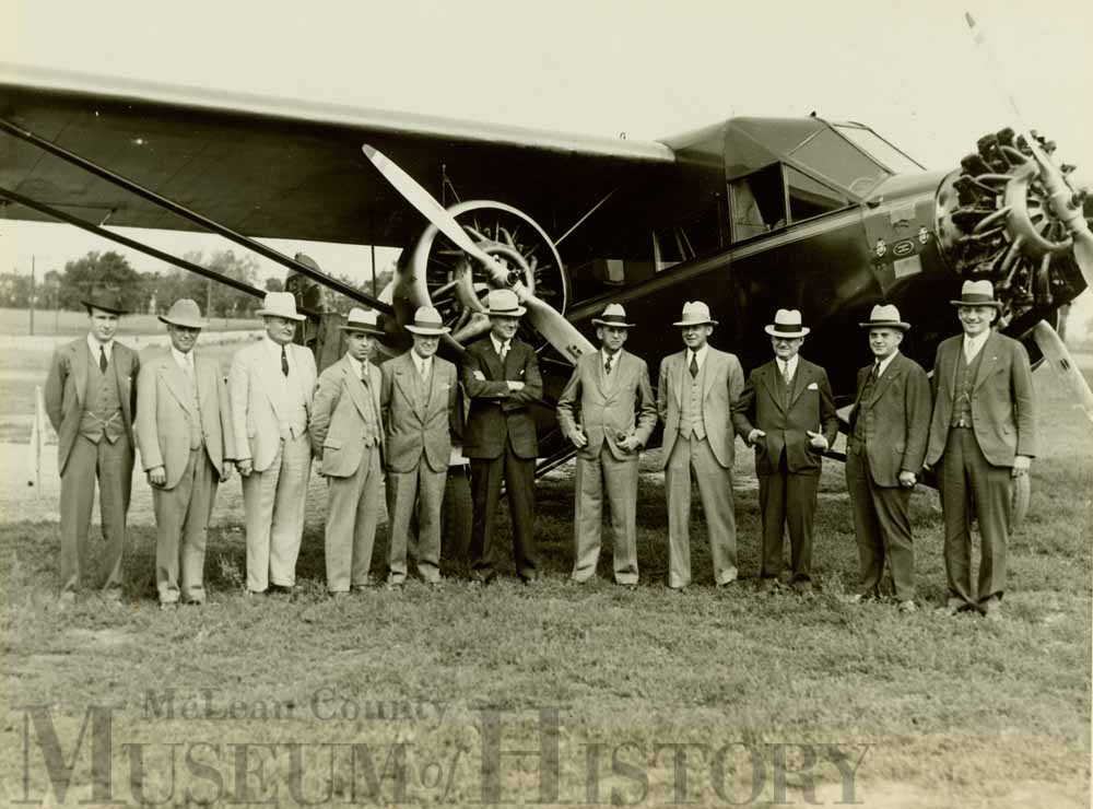 Men standing in front of Bloomington's first airport, 1931.