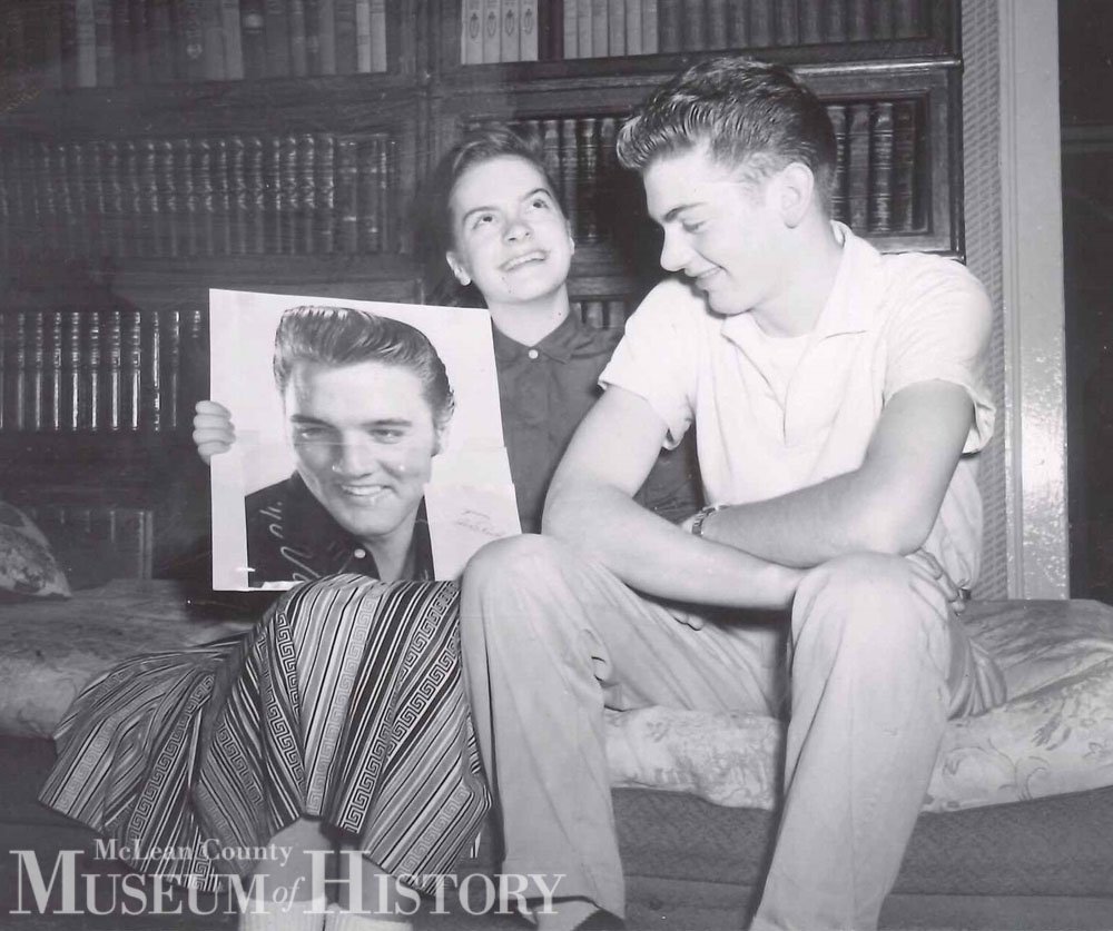 Teenagers holding a photo of Elvis, 1957.