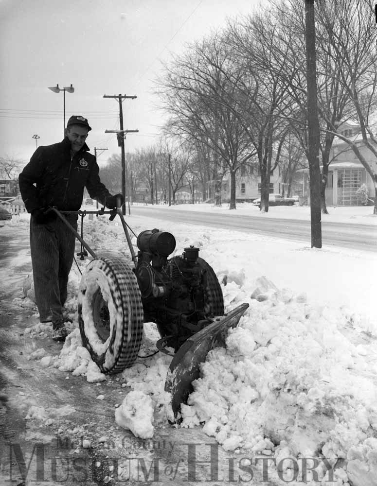 Two men out plowing the drive, 1953.