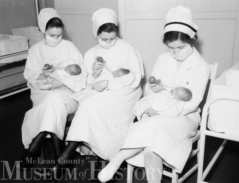 Nurses holding triplets, 1936.